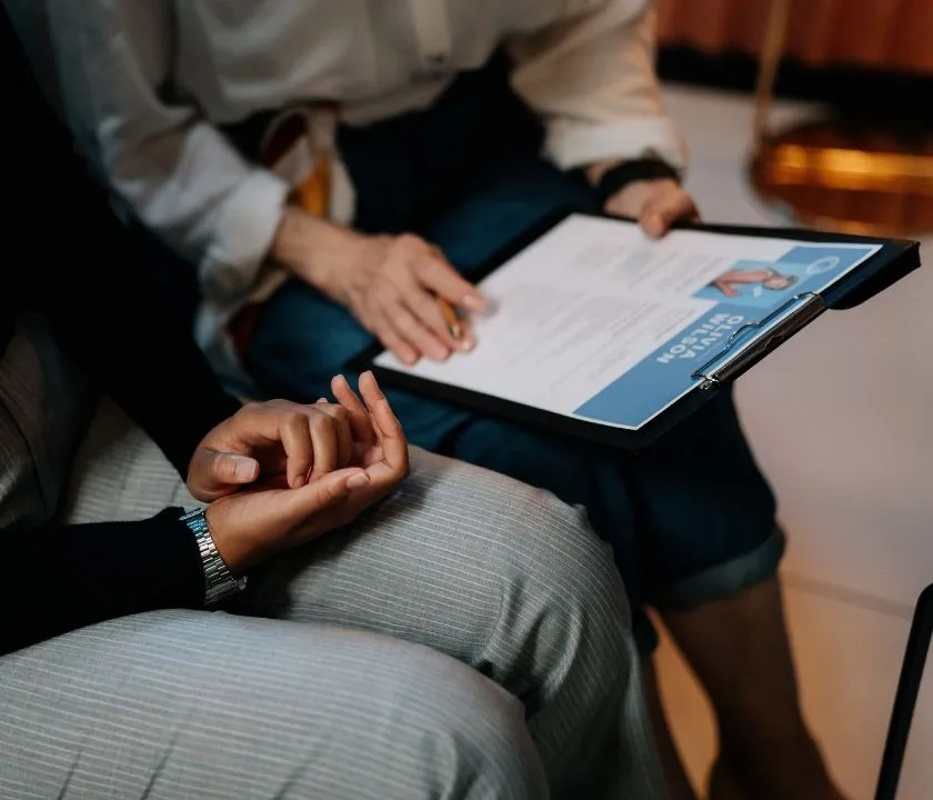 Two people sat down. There is a CV in the lab of one of the people.