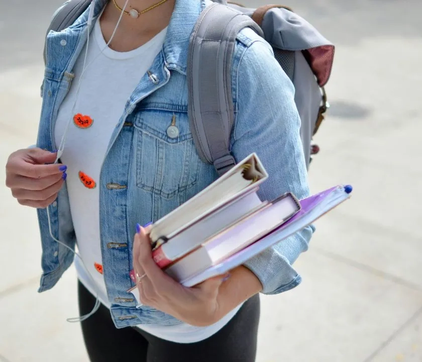 A student holding books